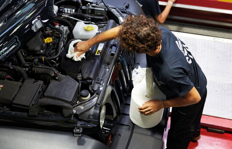 a worker using wiper rolls to clean the engine