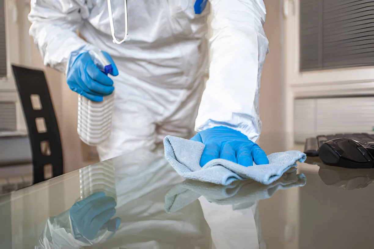 Doctor in covid hospital cleaning surfaces and disinfecting working space